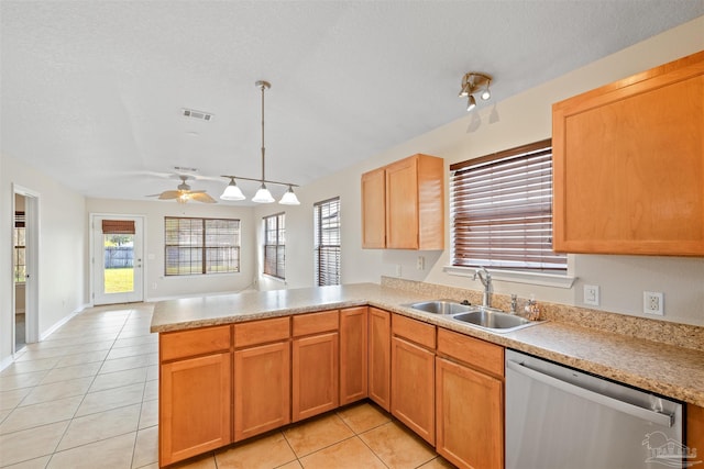 kitchen featuring light tile patterned floors, visible vents, a sink, dishwasher, and a peninsula