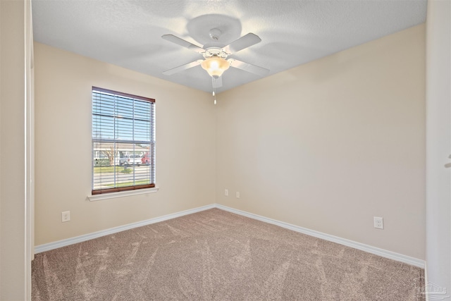 unfurnished room with carpet flooring, ceiling fan, a textured ceiling, and baseboards