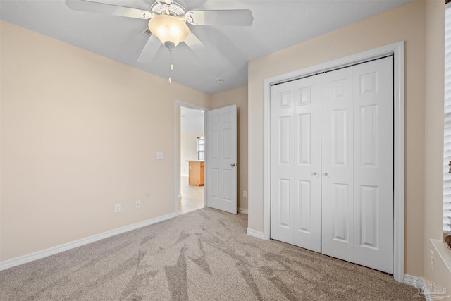 unfurnished bedroom featuring a ceiling fan, a closet, carpet flooring, and baseboards