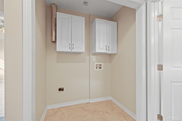 laundry room featuring washer hookup, light tile patterned flooring, and baseboards