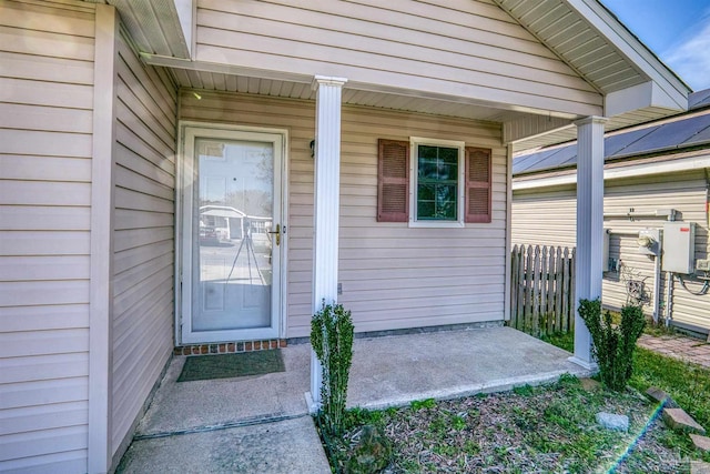 property entrance featuring a porch and fence