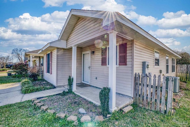 exterior space with fence and central AC unit