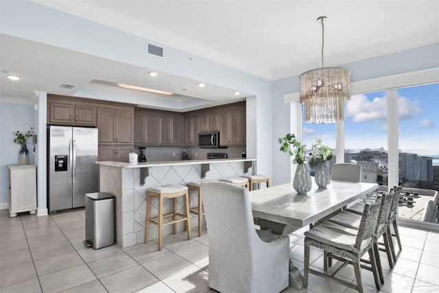 26688 Perdido Beach Blvd Unit 1605, Orange Beach, AL 36561 - dining area featuring crown molding, a chandelier, light tile patterned flooring, a raised ceiling, and recessed lighting