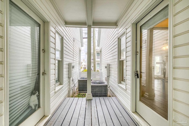 unfurnished sunroom with beam ceiling