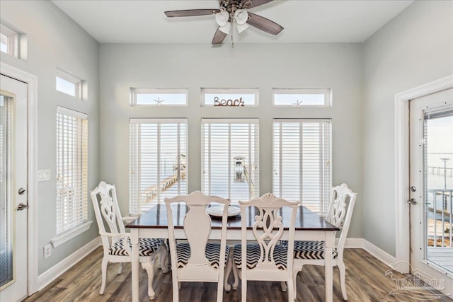 dining space with dark wood-type flooring and ceiling fan