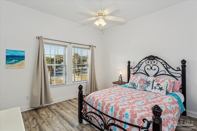 bedroom featuring hardwood / wood-style flooring and ceiling fan