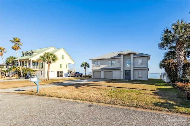 view of front of house with a garage and a front lawn