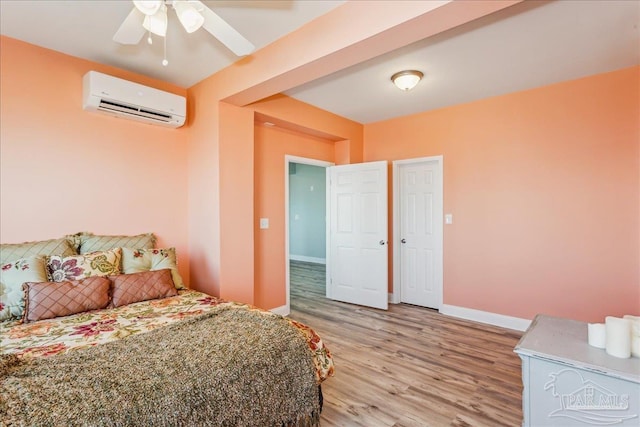 bedroom featuring a wall mounted air conditioner and light hardwood / wood-style floors