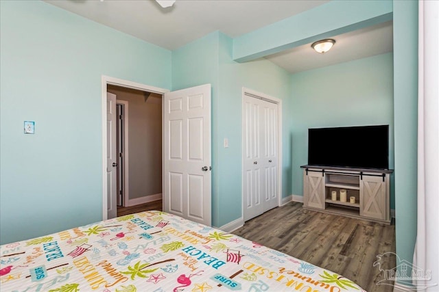 bedroom featuring dark hardwood / wood-style flooring and a closet