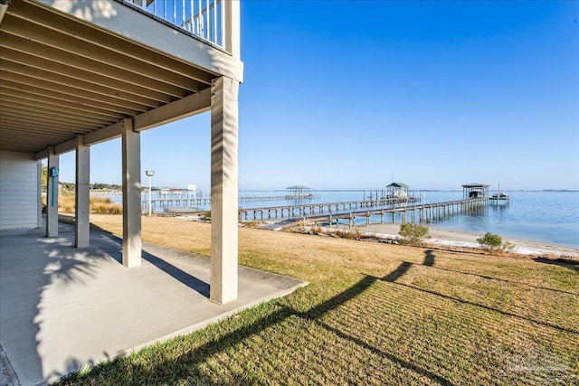 view of yard featuring a water view and a patio