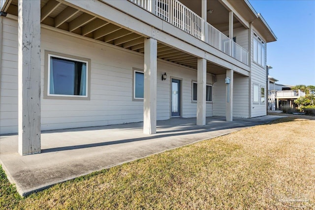 view of side of property with a yard and a patio area