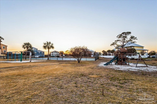 yard at dusk with a playground