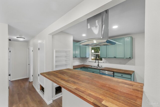 kitchen featuring dark hardwood / wood-style flooring, sink, butcher block counters, and island exhaust hood