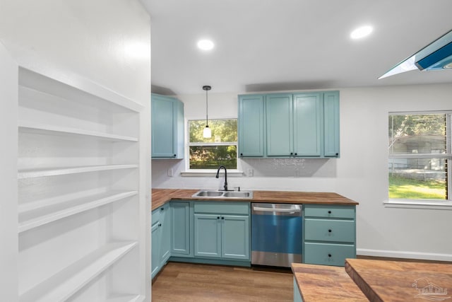 kitchen featuring sink, wooden counters, and stainless steel dishwasher