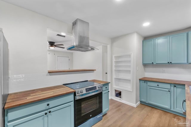 kitchen featuring wood counters, light wood-type flooring, island range hood, and stainless steel range with electric stovetop