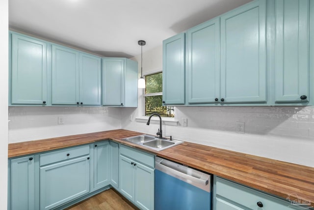 kitchen with dishwasher, sink, decorative light fixtures, and wooden counters