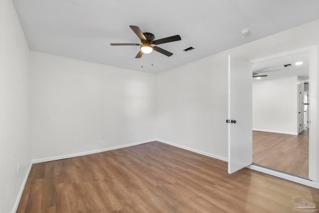 spare room featuring hardwood / wood-style floors and ceiling fan