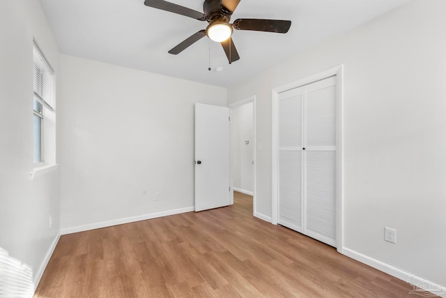 unfurnished bedroom featuring a closet, ceiling fan, and light hardwood / wood-style flooring