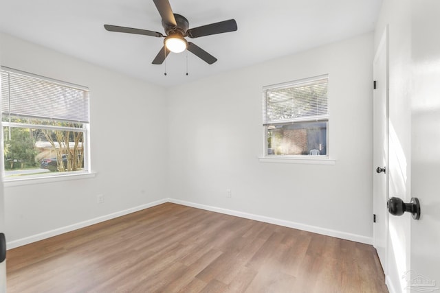 spare room with hardwood / wood-style flooring and ceiling fan