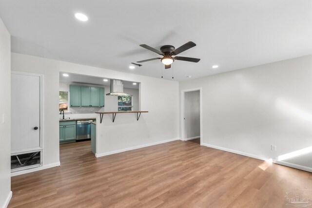 unfurnished living room featuring hardwood / wood-style floors and ceiling fan