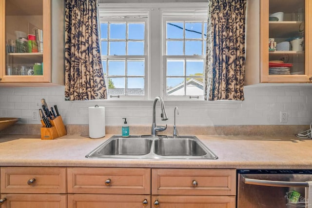 kitchen with light countertops, a sink, plenty of natural light, and dishwasher