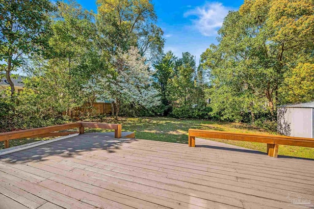 deck with an outbuilding and a storage shed