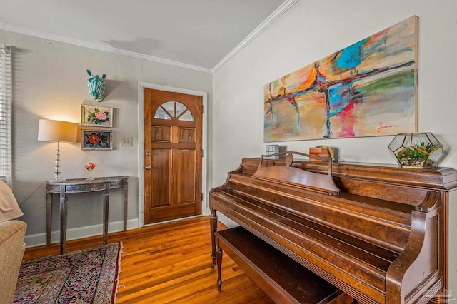 entrance foyer featuring crown molding, baseboards, and wood finished floors