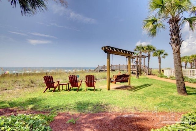 view of yard with a water view, fence, and a pergola