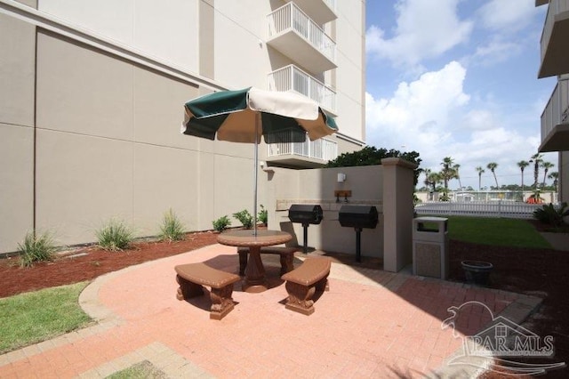 view of patio with fence and area for grilling