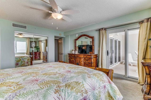 bedroom featuring a textured ceiling, light carpet, visible vents, access to exterior, and a closet