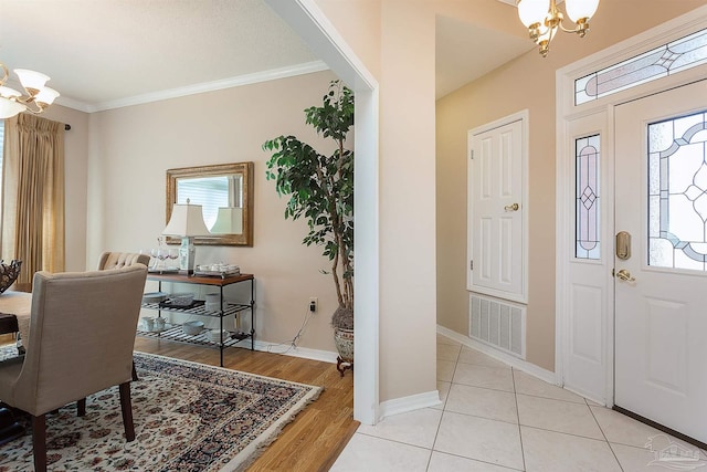 1424 Champions Green Dr, Gulf Breeze, FL 32563 - foyer with crown molding, visible vents, an inviting chandelier, and light tile patterned floors