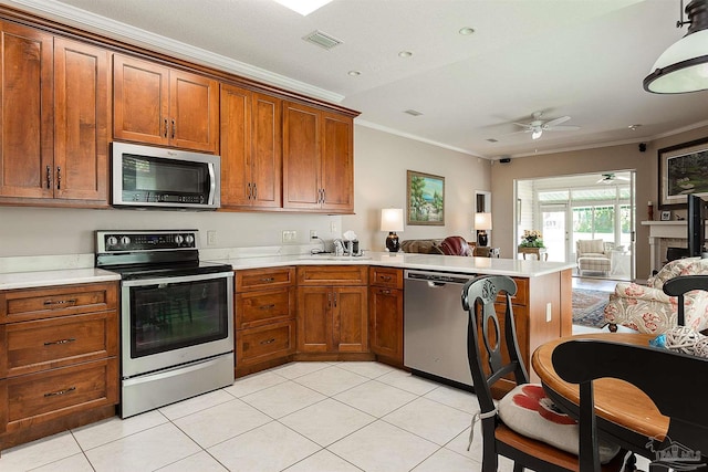 1424 Champions Green Dr, Gulf Breeze, FL 32563 - kitchen featuring visible vents, open floor plan, ceiling fan, a peninsula, and stainless steel appliances