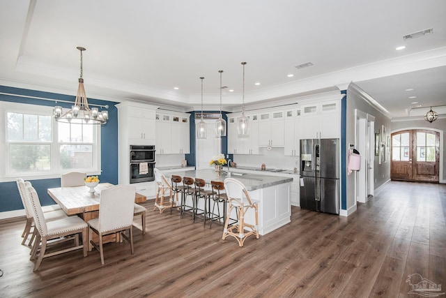 kitchen featuring dark hardwood / wood-style flooring, black double oven, pendant lighting, white cabinets, and stainless steel fridge with ice dispenser