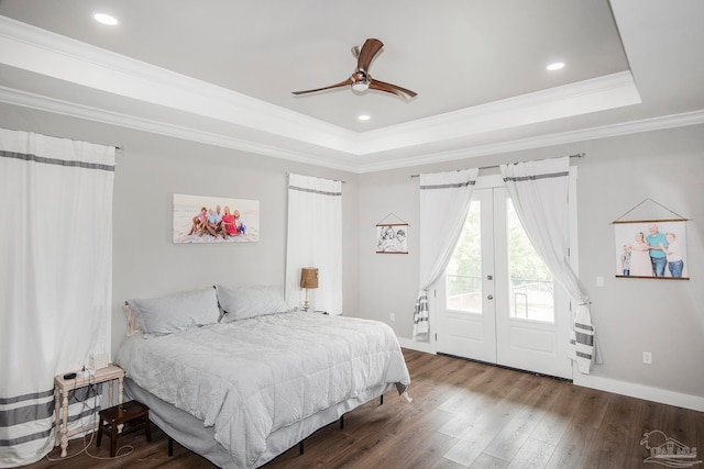 bedroom with a raised ceiling, ceiling fan, access to exterior, ornamental molding, and wood-type flooring