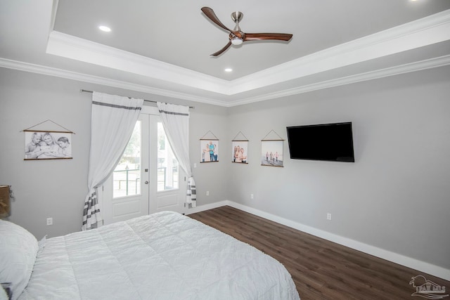 bedroom with ceiling fan, access to exterior, ornamental molding, a tray ceiling, and wood-type flooring