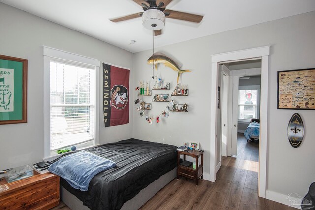 bedroom featuring ceiling fan and dark hardwood / wood-style floors