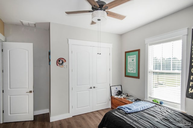 bedroom with ceiling fan, a closet, and dark hardwood / wood-style floors