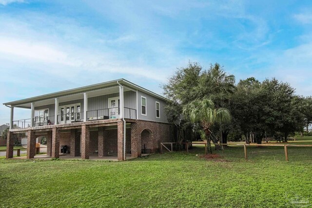 rear view of house with a yard