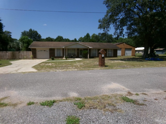 single story home featuring a front yard and a garage