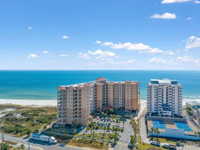 birds eye view of property with a water view and a beach view