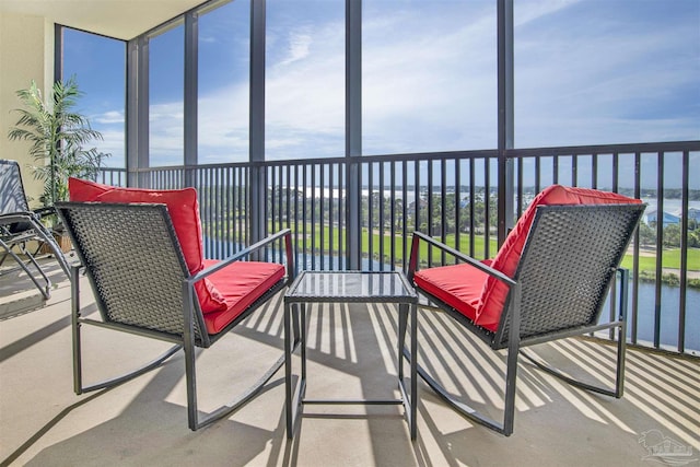 sunroom / solarium with a water view