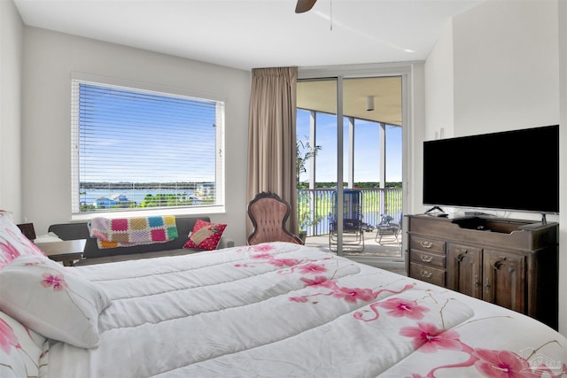 bedroom featuring access to outside, expansive windows, and ceiling fan