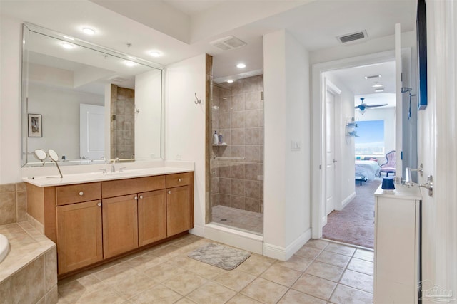 bathroom with tile patterned floors, vanity, separate shower and tub, and ceiling fan