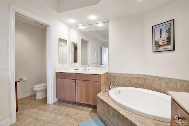 bathroom with vanity, a relaxing tiled tub, tile patterned floors, and toilet