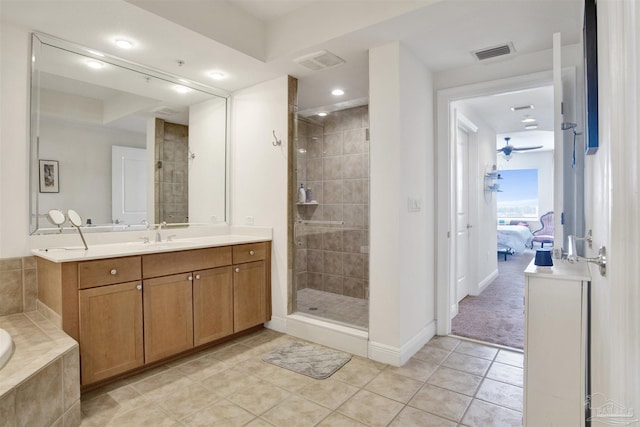 bathroom featuring a shower with door, vanity, tile patterned floors, and ceiling fan