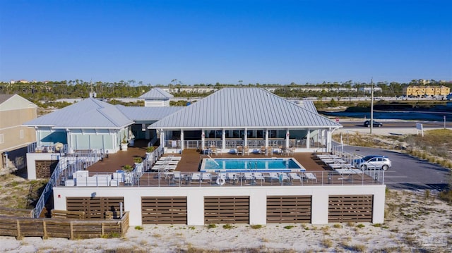 back of house featuring a community pool and a patio area