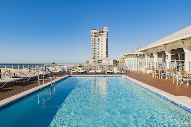 view of swimming pool with a water view