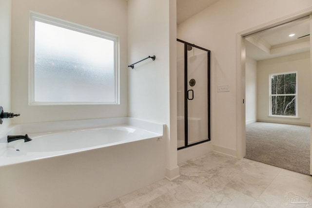 bathroom with a shower stall and a bath