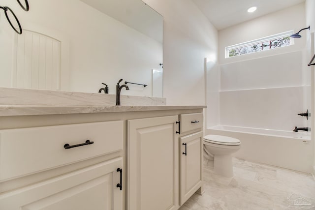 full bath featuring marble finish floor, recessed lighting, toilet, washtub / shower combination, and vanity