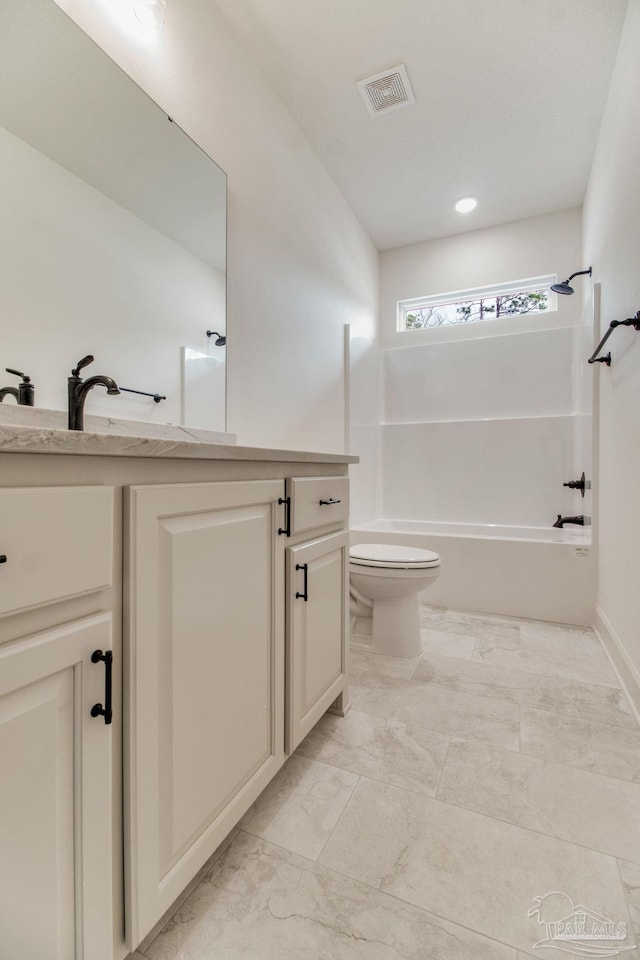 bathroom featuring toilet, visible vents, vanity, marble finish floor, and washtub / shower combination